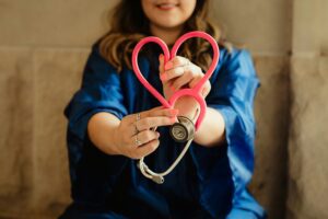 Doctor holds stethoscope confirming the good news about sobriety includes improved medical conditions